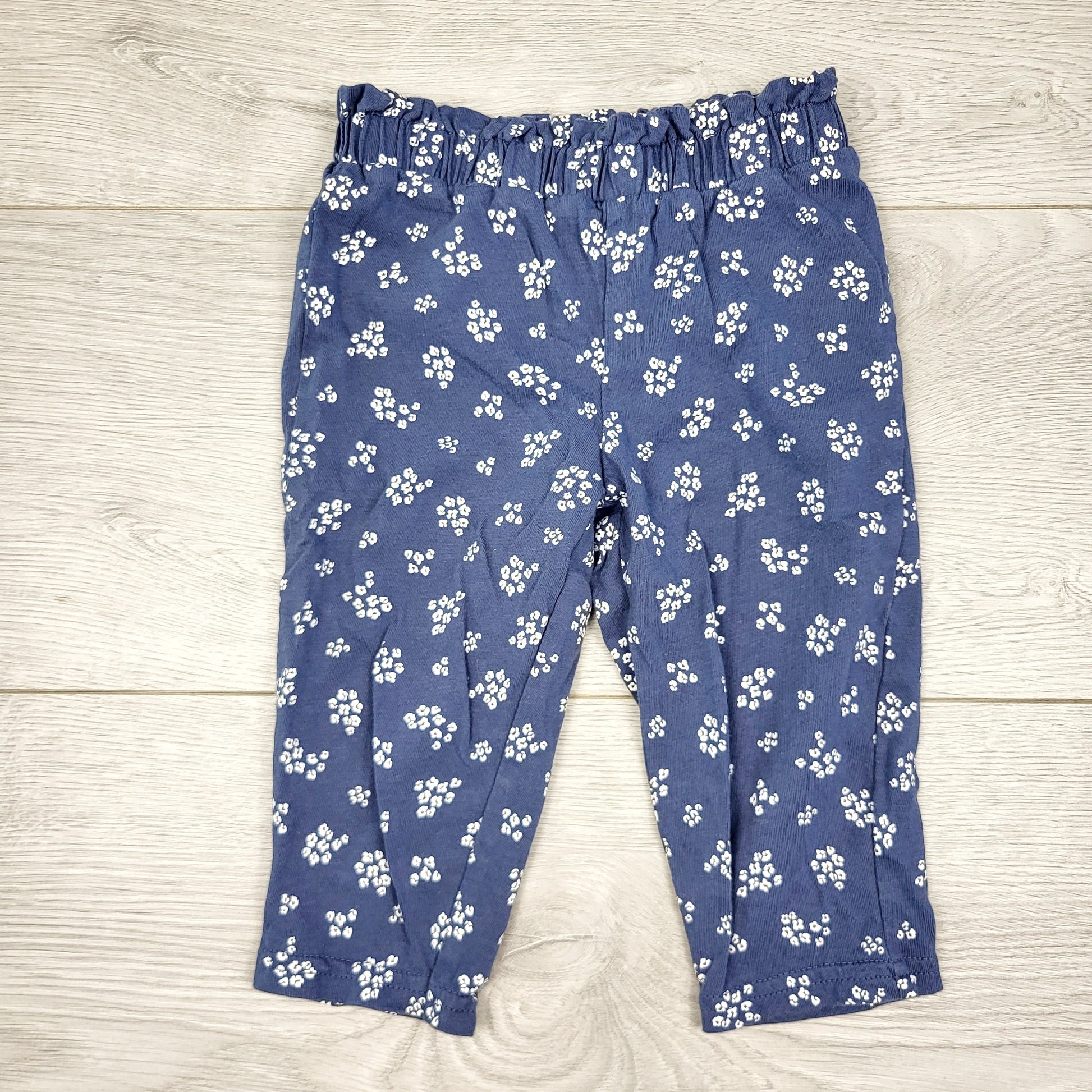CAAC1 - Pantalon Carters en coton bleu à imprimé floral avec taille à volants. Taille 9 mois