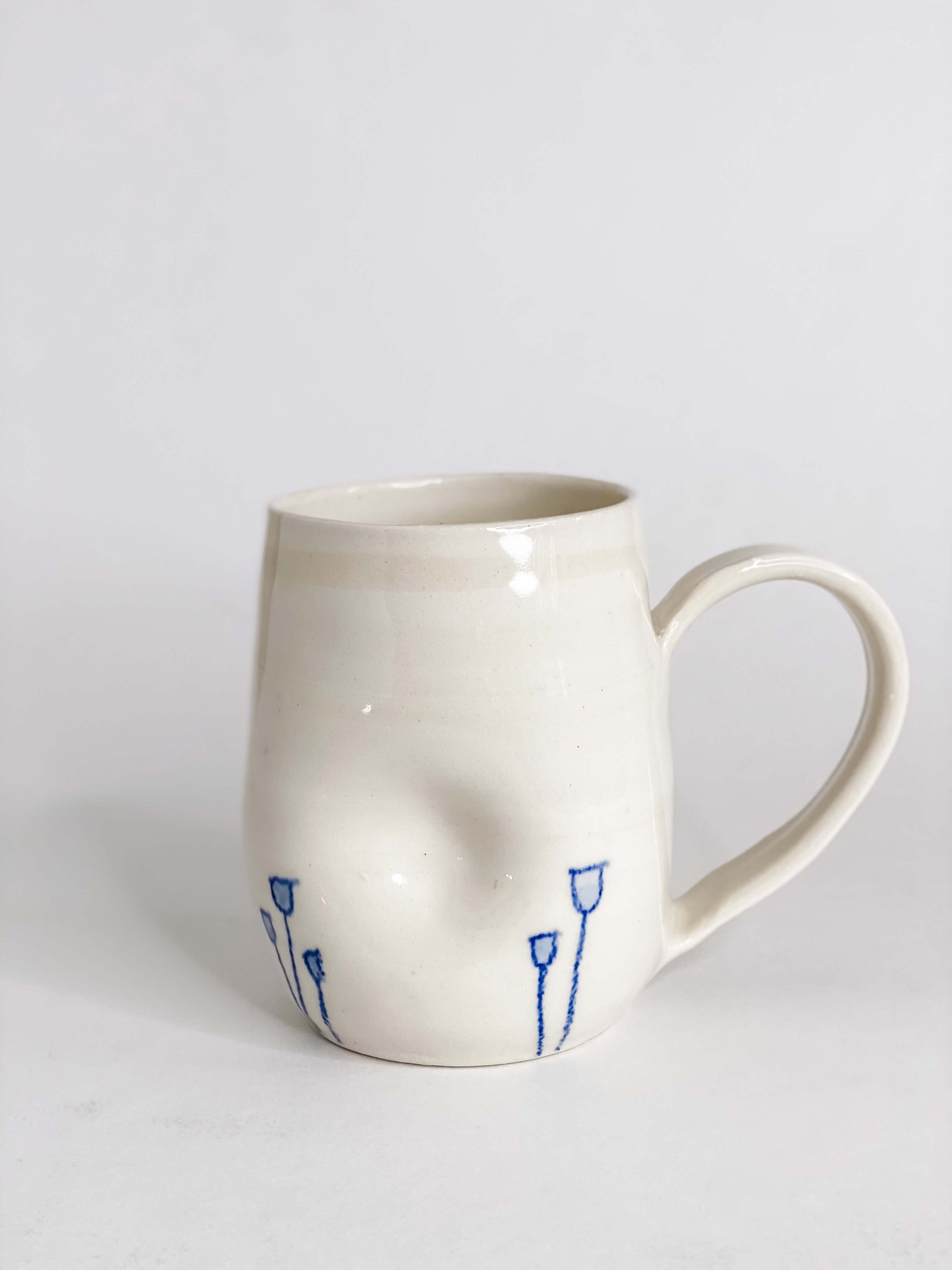 Indented Blue Tulip Mugs in White Porcelain