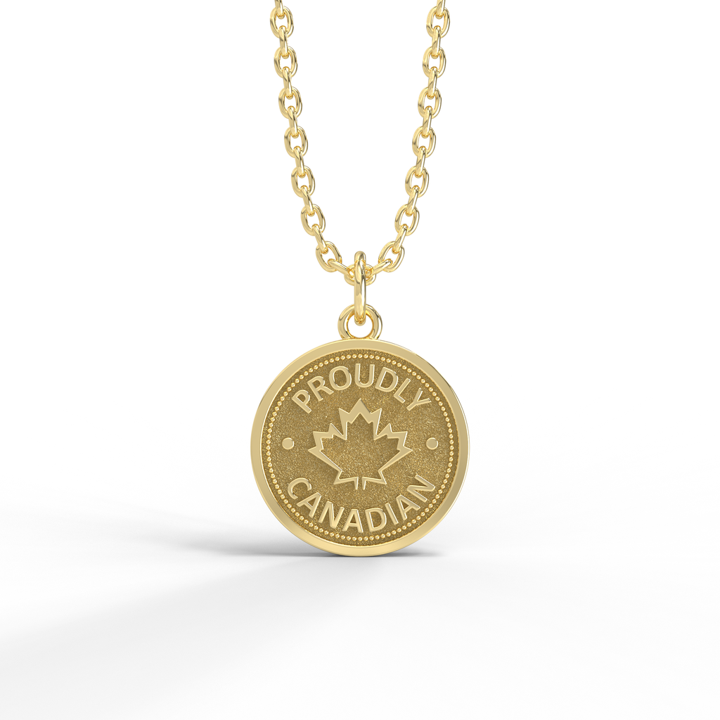 Silver coin-shaped pendant with the text 'Proudly Canadian' and a maple leaf design, attached to a silver chain against a white background.