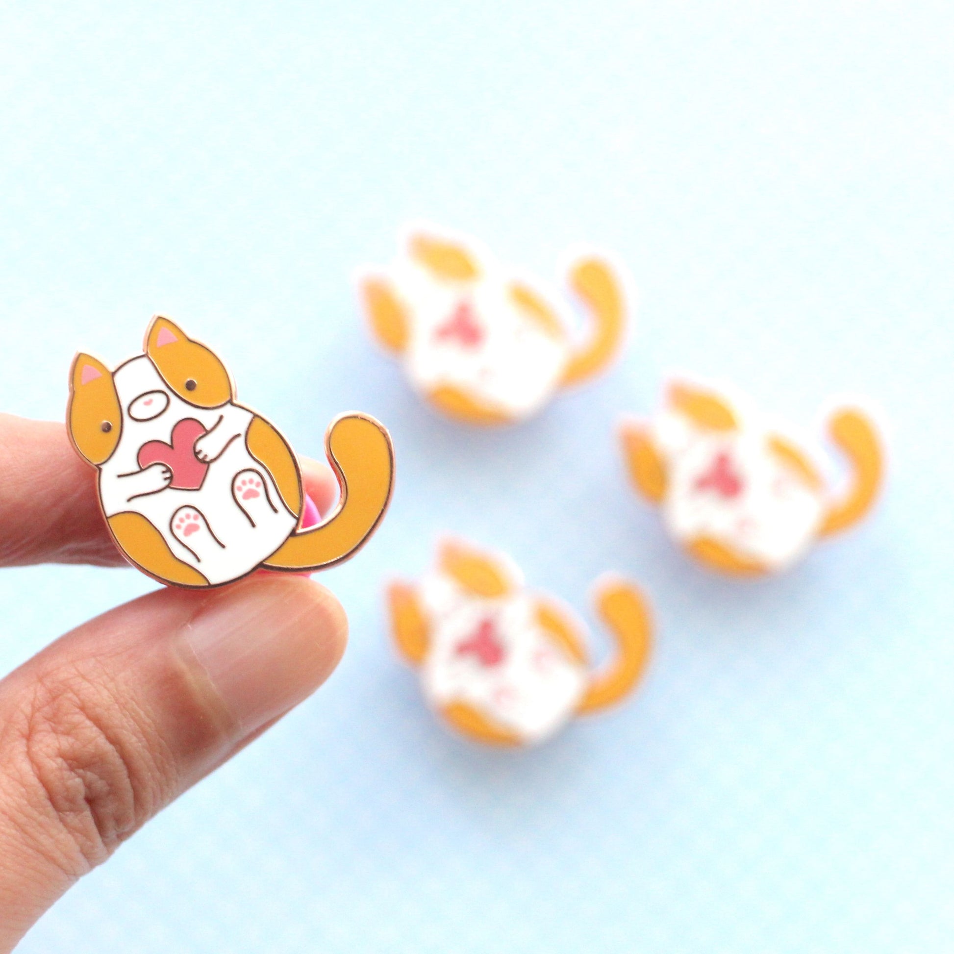 Pin's chat orange et blanc. Pin's en émail chaton