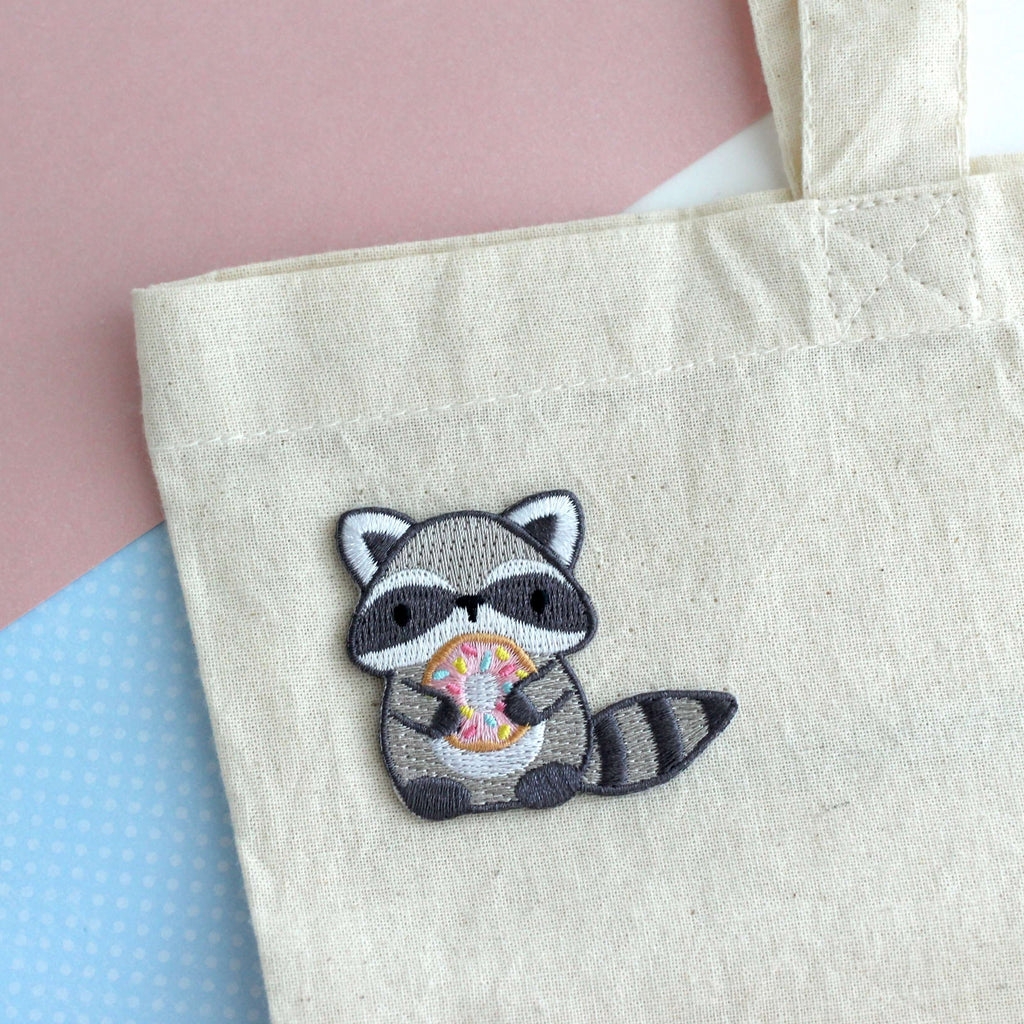Raccoon Holding Donut Iron-On Embroidered Patch