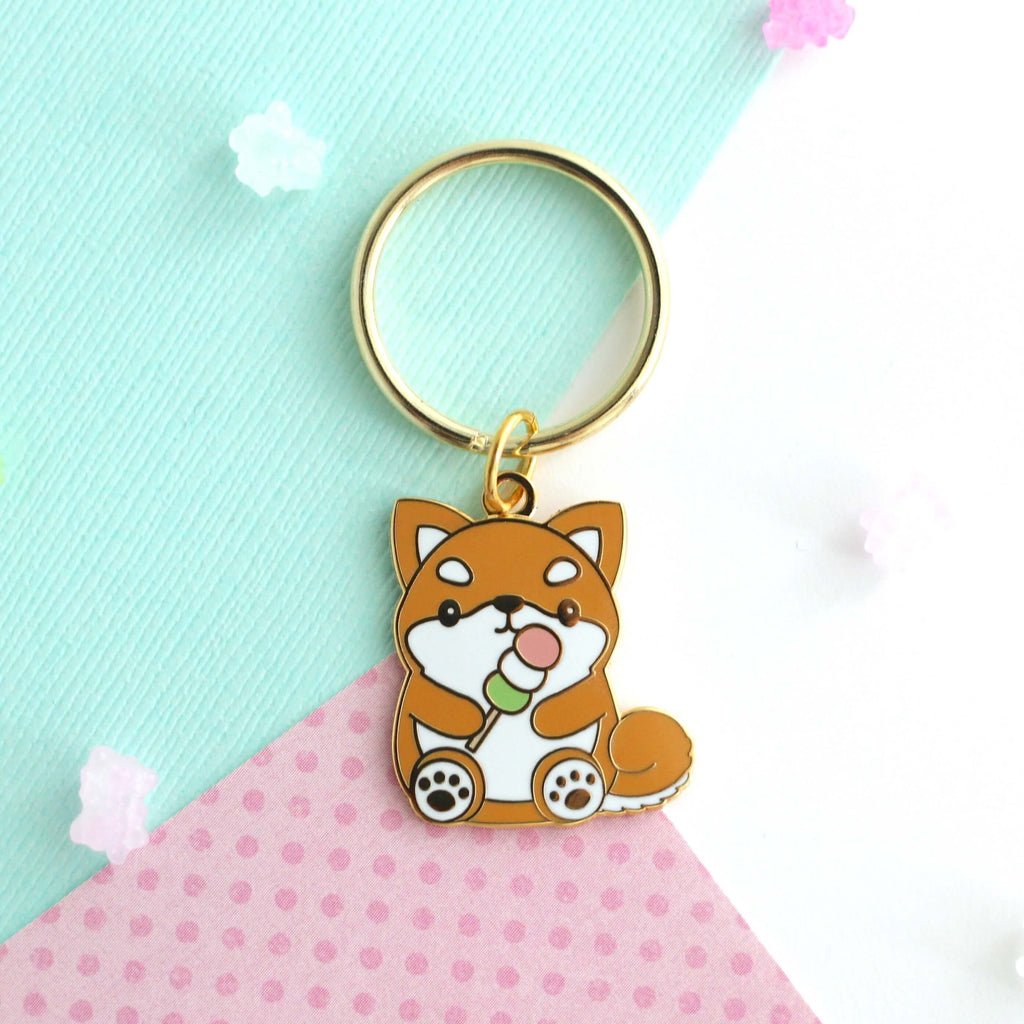 Shiba Inu holding a Dango Enamel Keychain