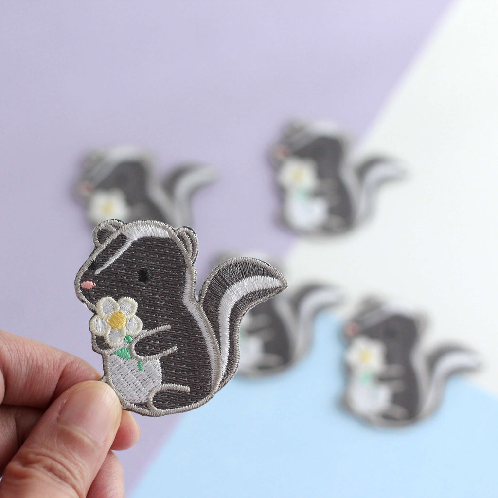 Skunk and Daisy Embroidered Iron-On Patch