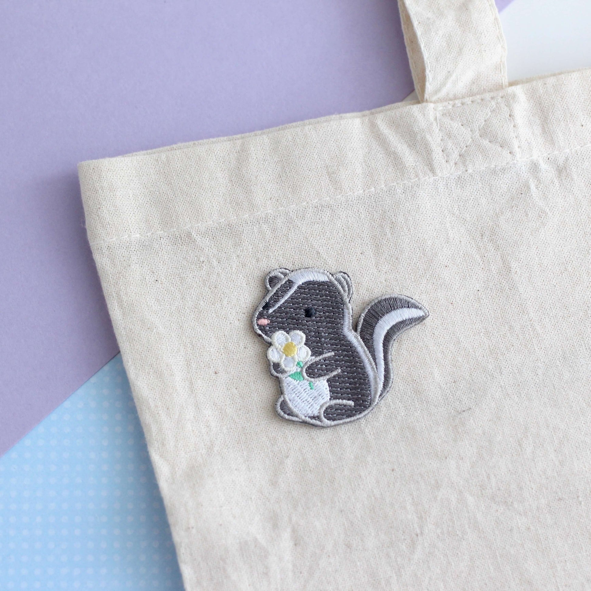 Skunk and Daisy Embroidered Iron-On Patch