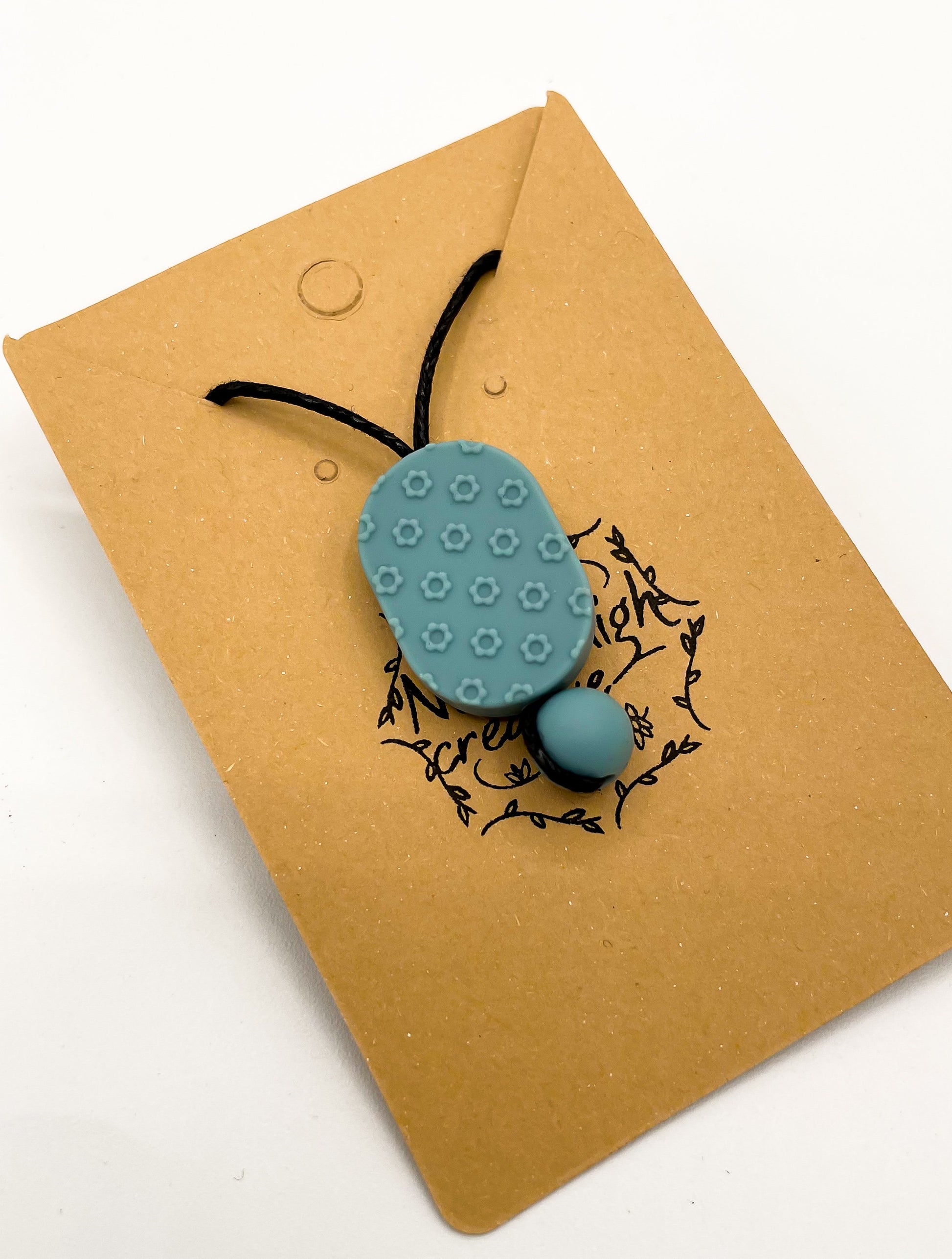 Collier à mâcher ovale à motif floral de moutarde bleue