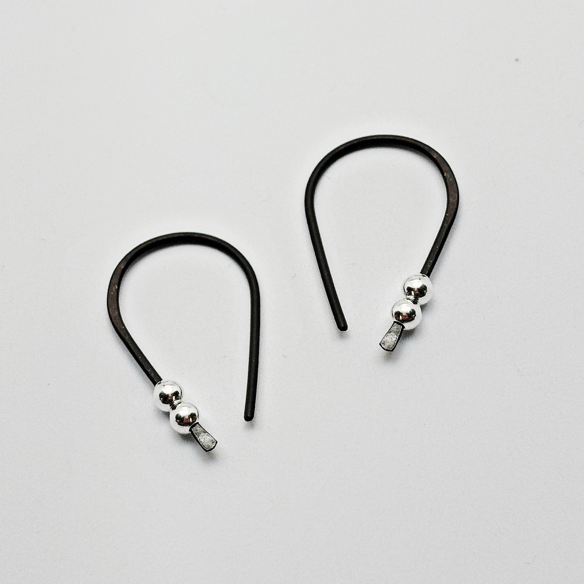 Black Niobium hoop earrings. Small 3/4" hoops. Silver accent beads. Hypoallergenic
