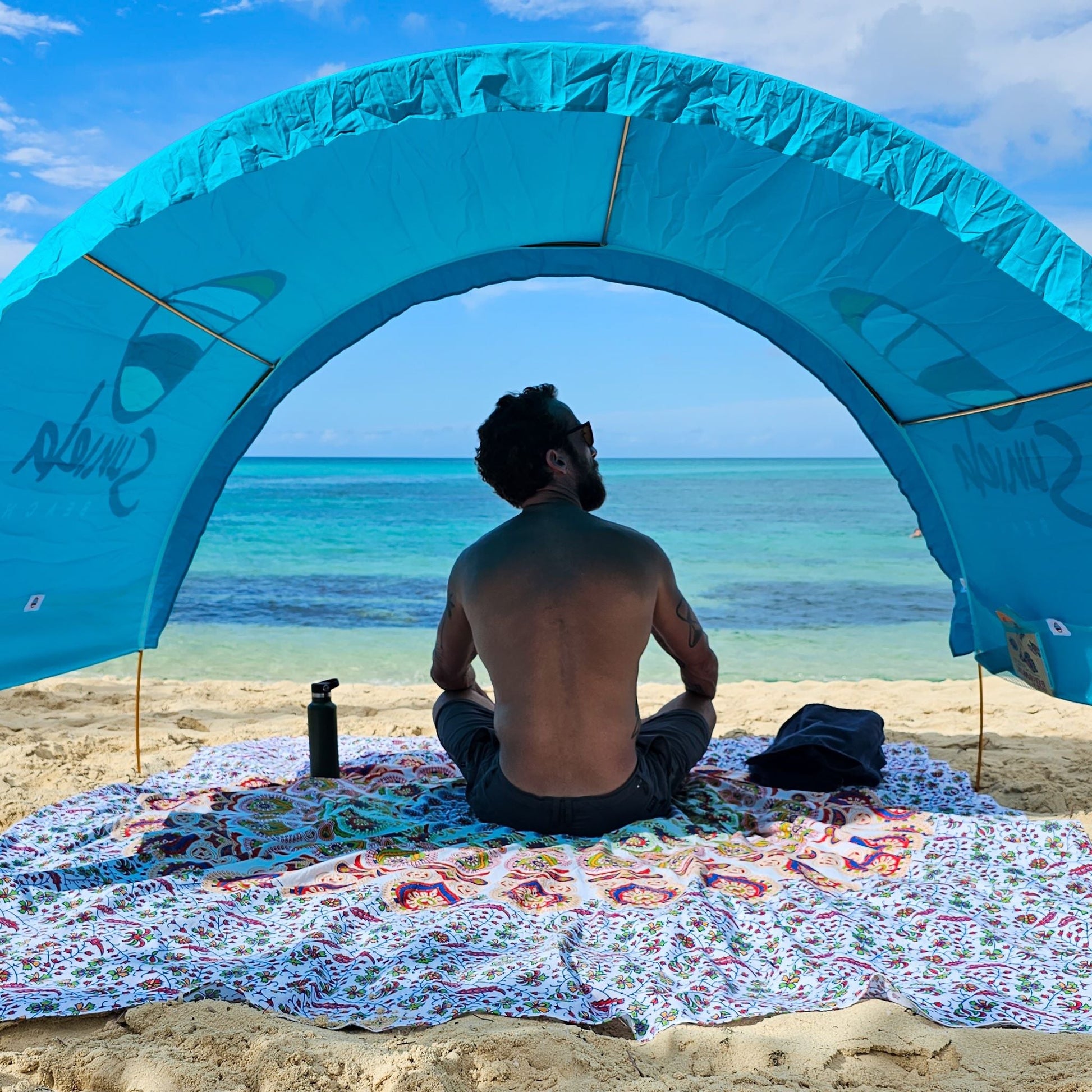 Turquoise Suniela Deluxe beach cabana providing UPF 50+ shade on sand